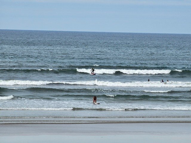 Surfer riding a shoulder high wave in front of the shop
